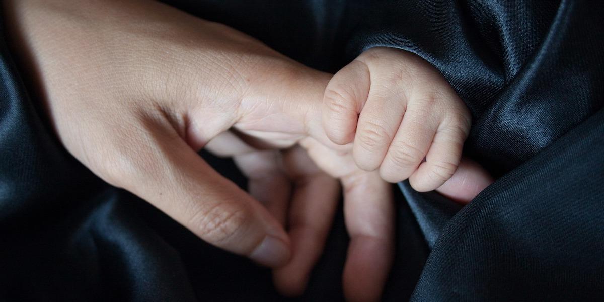 Et spädbarns hand håller en vuxen hands finger. En grupp forskare har analyserat hundratals studier för att ta reda på hur viktig beröring är för vår fysiska och mentala hälsa