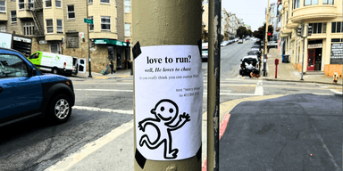Tecknad figur på affisch uppklistrad på elstolpe i San Francisco, del av det anonyma stadspelet PURSUIT.