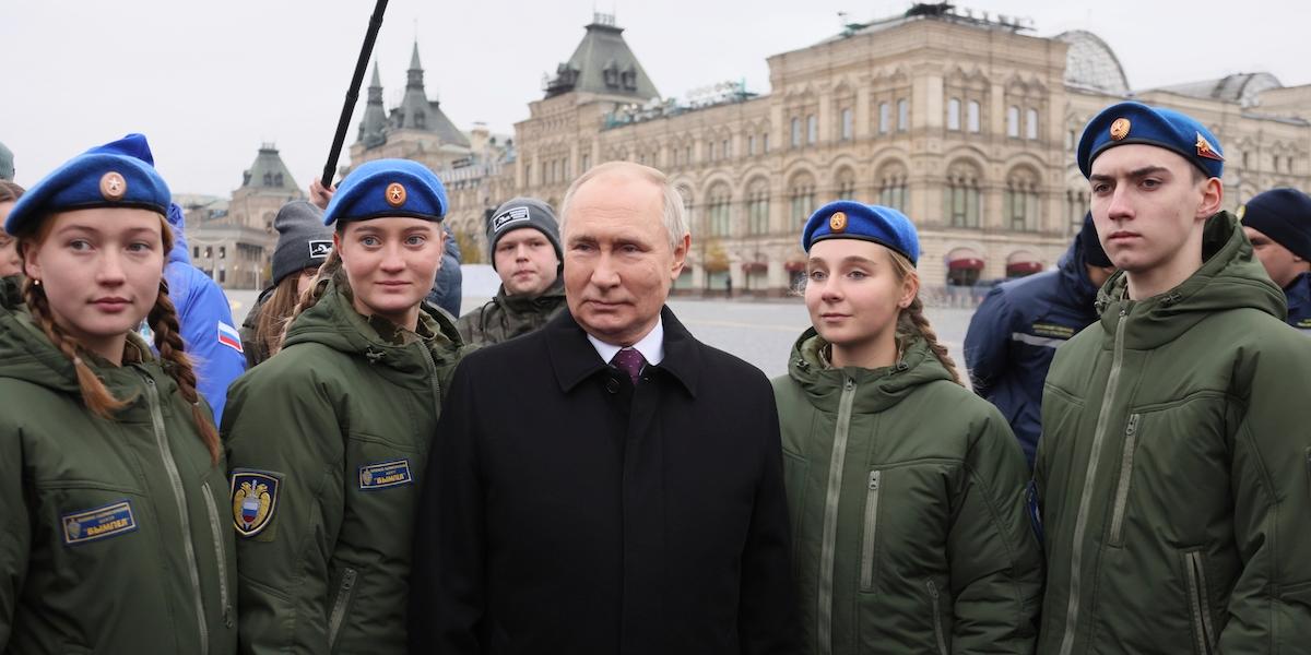 Rysslands president Vladimir Putin poserar med medlemmar i ryska Unga armékadetters nationella folkrörelse och barn till soldater som dött i Ukraina, under Rysslands nationella enhetsdag den 4 november i år