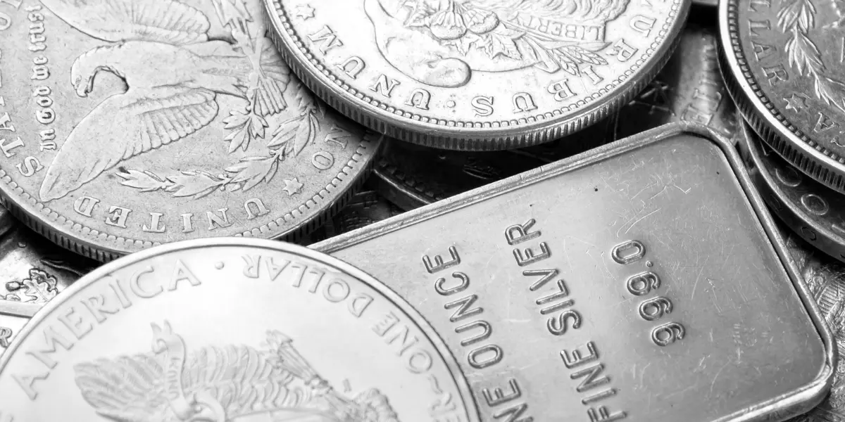 Närbild på silvermynt och silvertacka med texten "One Ounce Fine Silver 0.999" – symbol för stigande efterfrågan och prisökning på silver 2025.